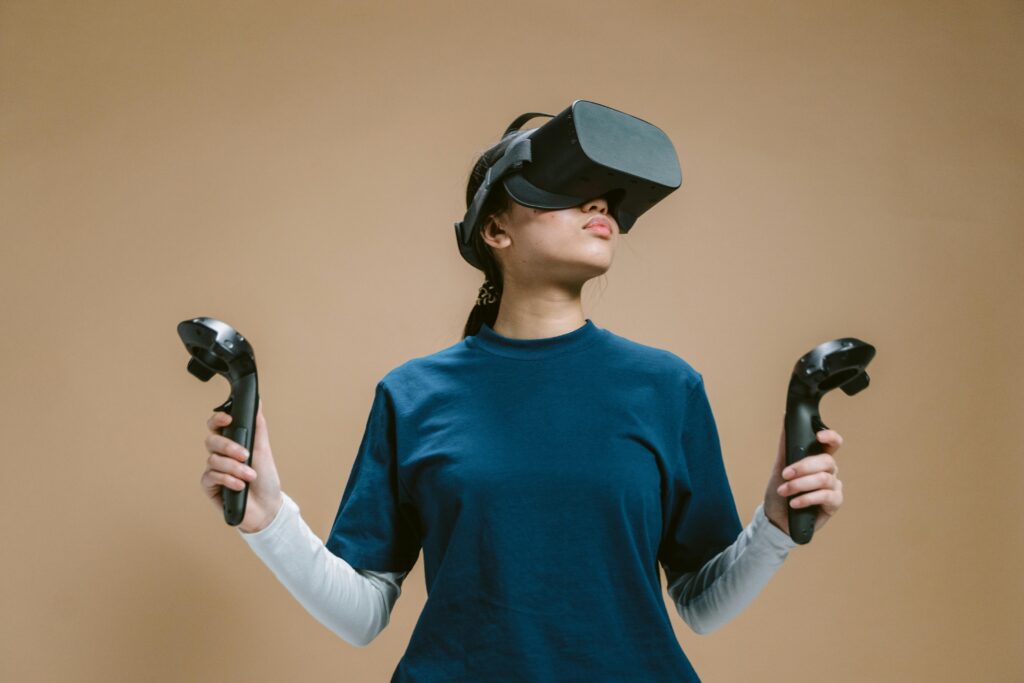 A young woman using a virtual reality headset and controllers, fully engaged in a gaming session.